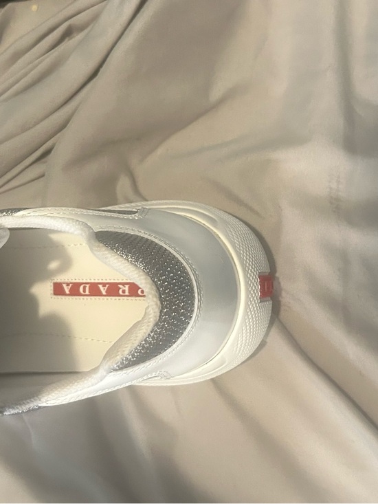 Prada Other - Prada White Slip-On Sneaker with Silver Mesh and Red Logo